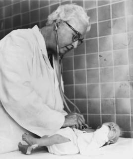 Virginia Apgar listening to an infant's heart, 1966 