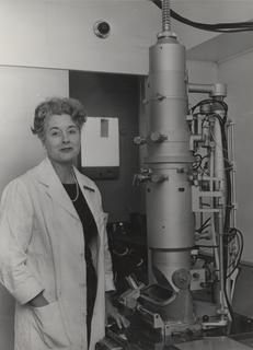Lynn Reid standing by an electron microscope at the Cardiothoracic Institute, London University, ca. 1970
