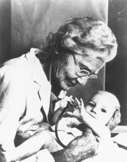 Helen Taussig examining a baby, 1970s