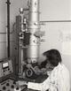 Ruth Bleier looking into her electron microscope, 1980's