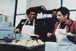Surgeon General Joycelyn Elders and Secretary of the Department of Health and Human Services, Donna Shalala at a soup kitchen, 1994