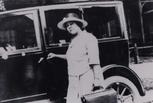 Justina Carter Ford on a house call in front of her car, 1920s