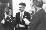 Surgeon General Antonia Novello is sworn in, as her husband, Dr. Joseph Novello, holds the Bible, March 9, 1990  